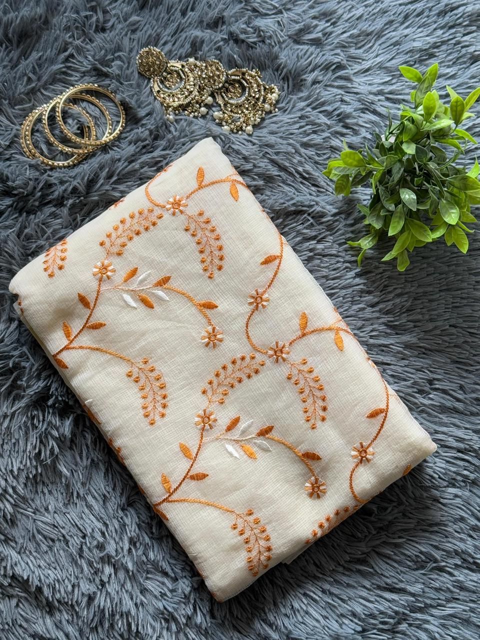 Ivory white Kota Doria saree with orange floral embroidery detailing