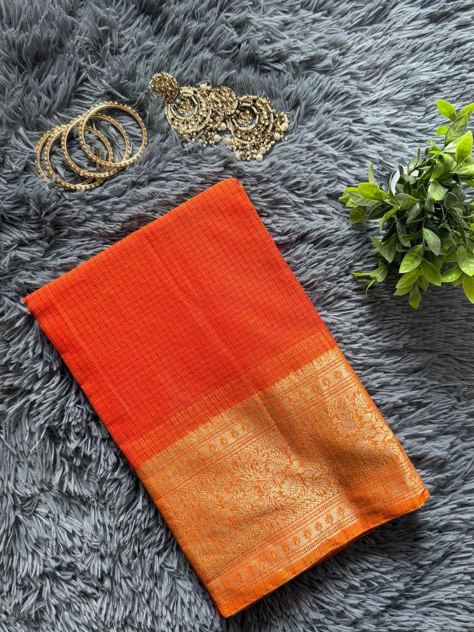 Vibrant sunset orange Kota Doria saree with heavy gold zari border