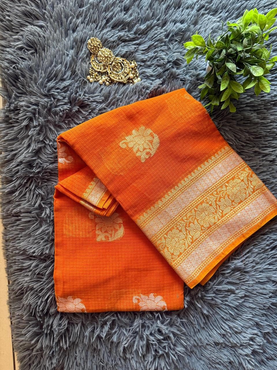 Tangerine orange Kota silk saree with gold zari motifs and a woven floral border